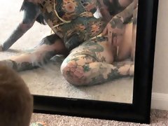 Tattooed couple having wild sex in front of the mirror